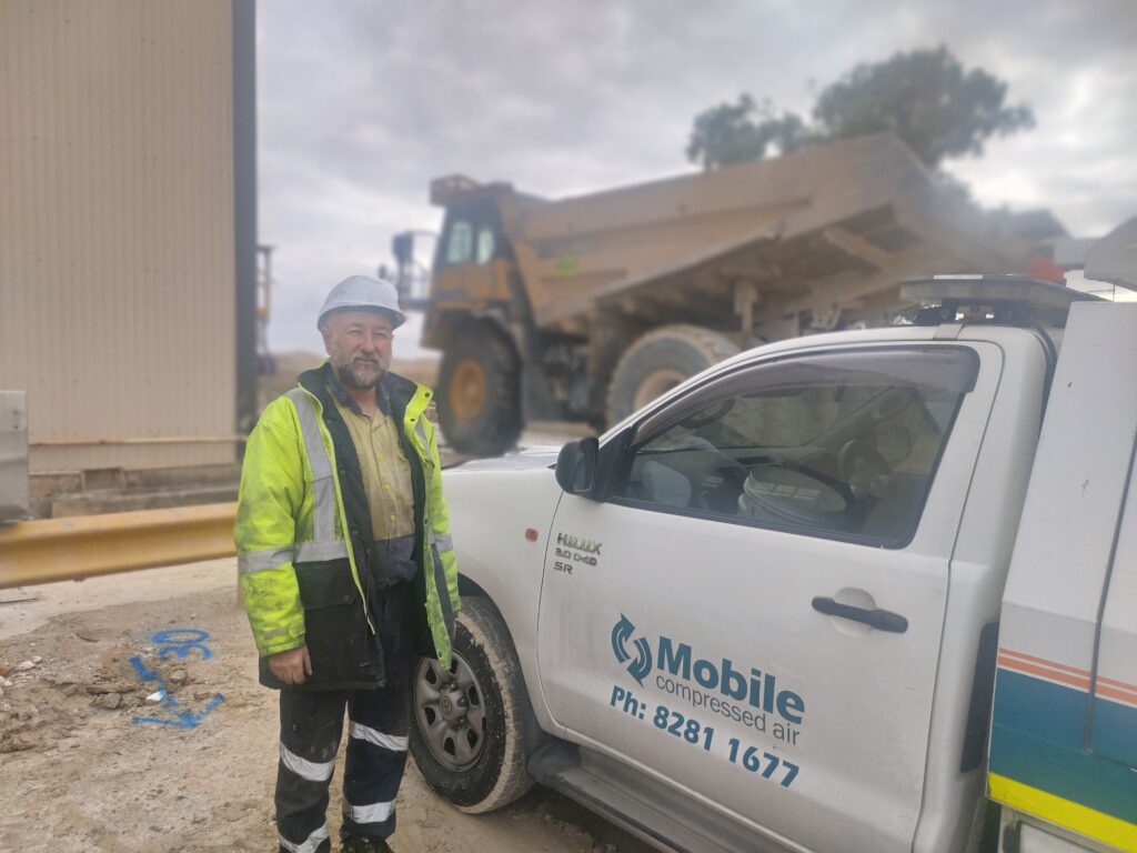 IMG20220602125919 Compressed Air Analysis 3 MCA technician standing onsite in front of his mobile service truck